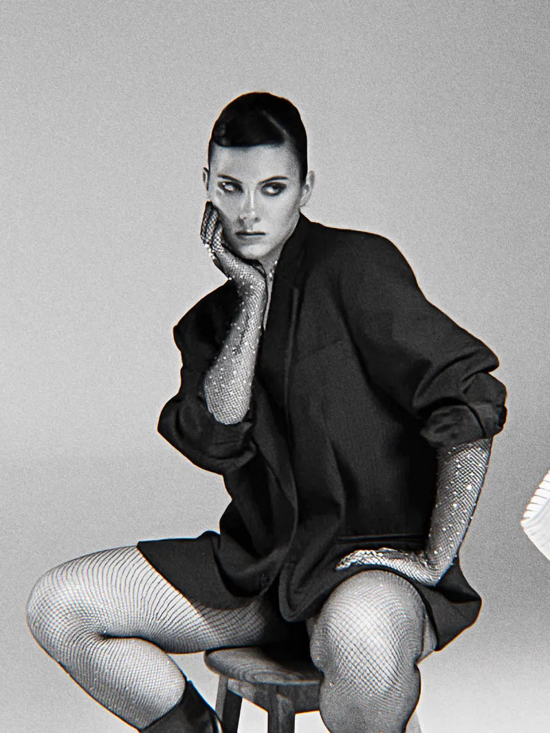 Black and white portrait in an oversized blazer and fishnets